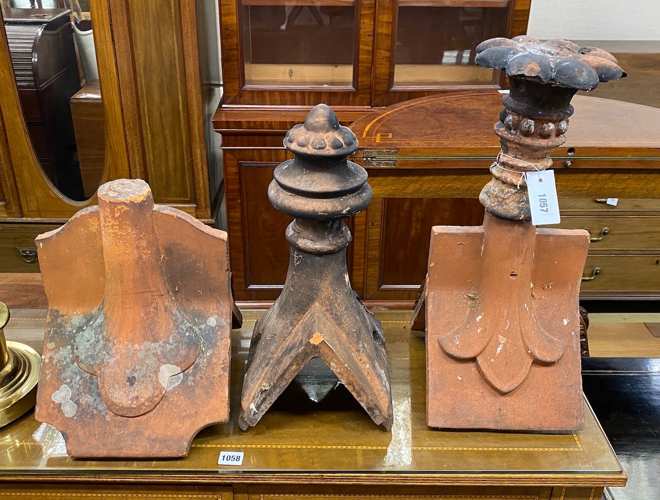 Three Victorian terracotta hip tiles, largest height 50cm